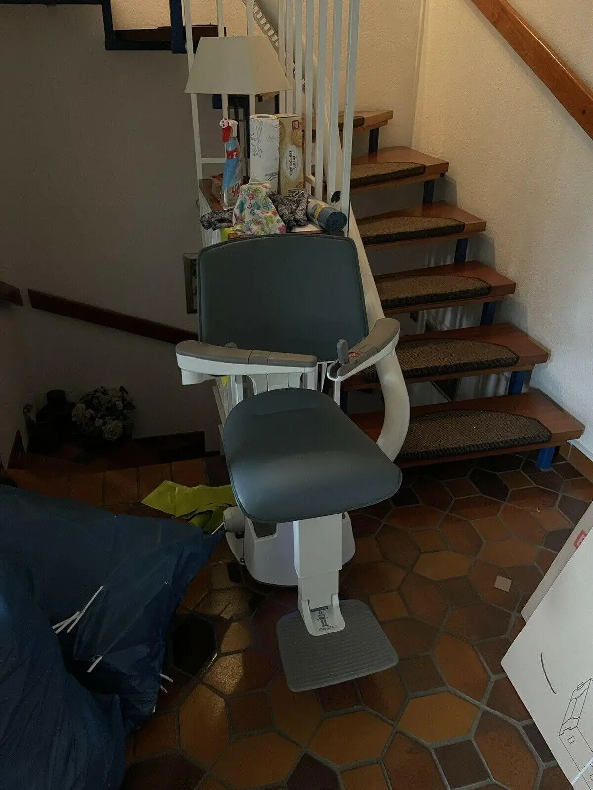 Modern seat lift on staircase landing in a two-family home in Shidler