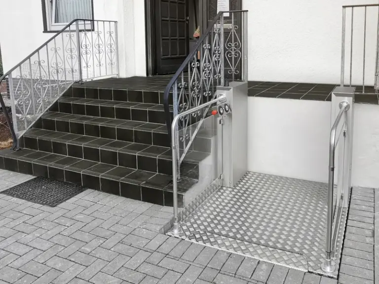 Outdoor vertical platform lift by SaniTrans with gated entry