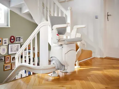 Bright interior curved stairlift on a wooden staircase in Fort Myers Beach.