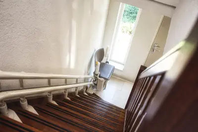 Overhead top-down view of a curved stairlift installation in Shidler.